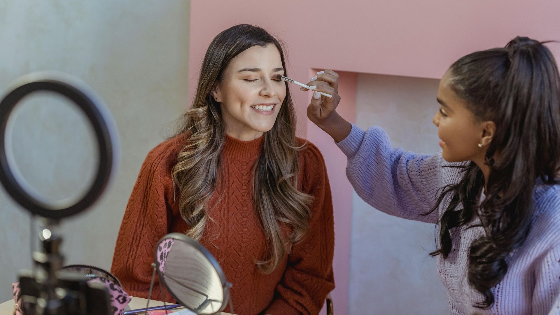 a beautition applying cosmetics on a women